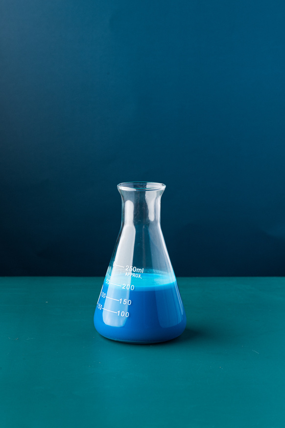 Flask with Liquid on Blue Background